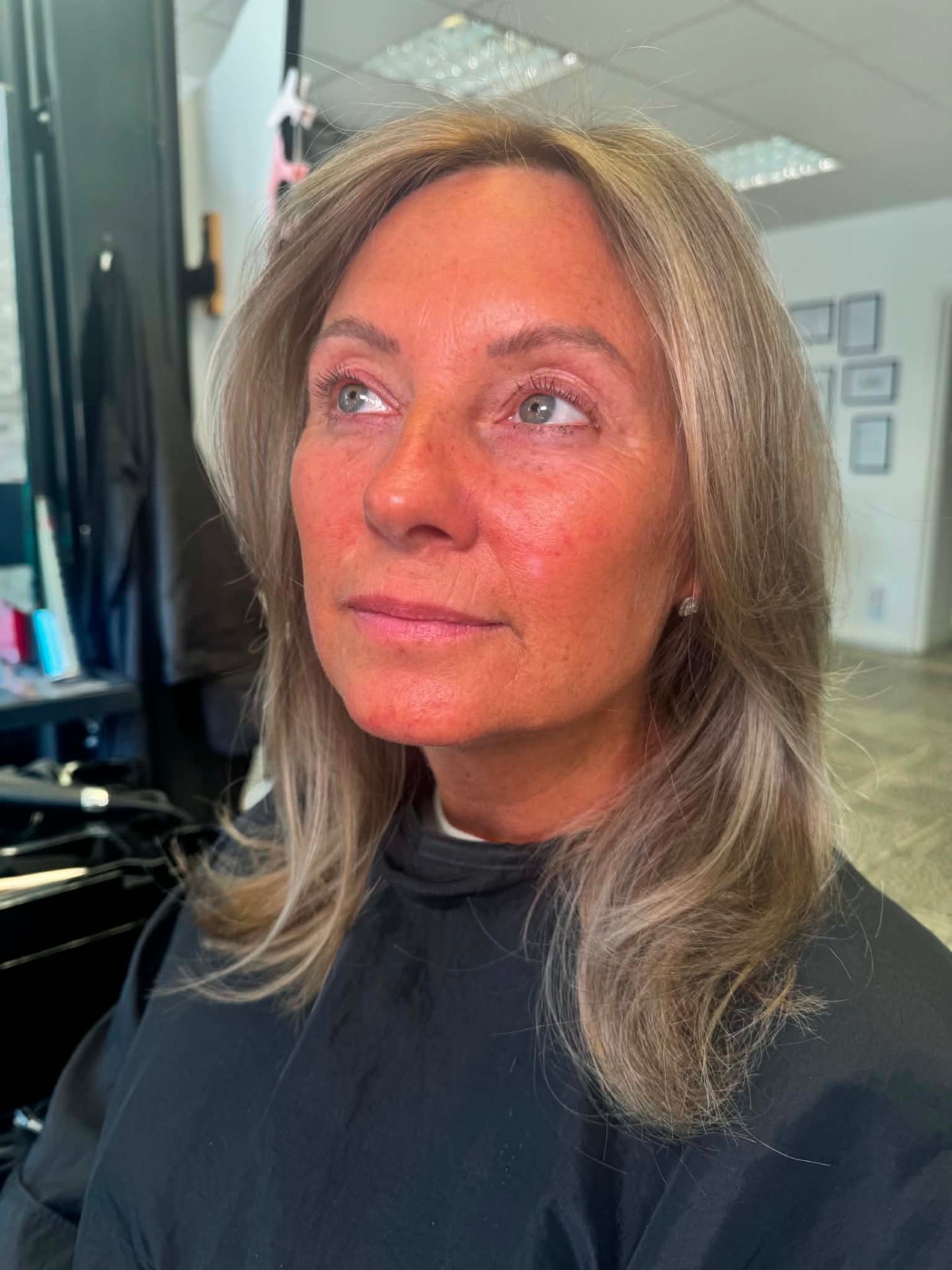 Ash blonde mid-length shaggy cut with face-framing layers