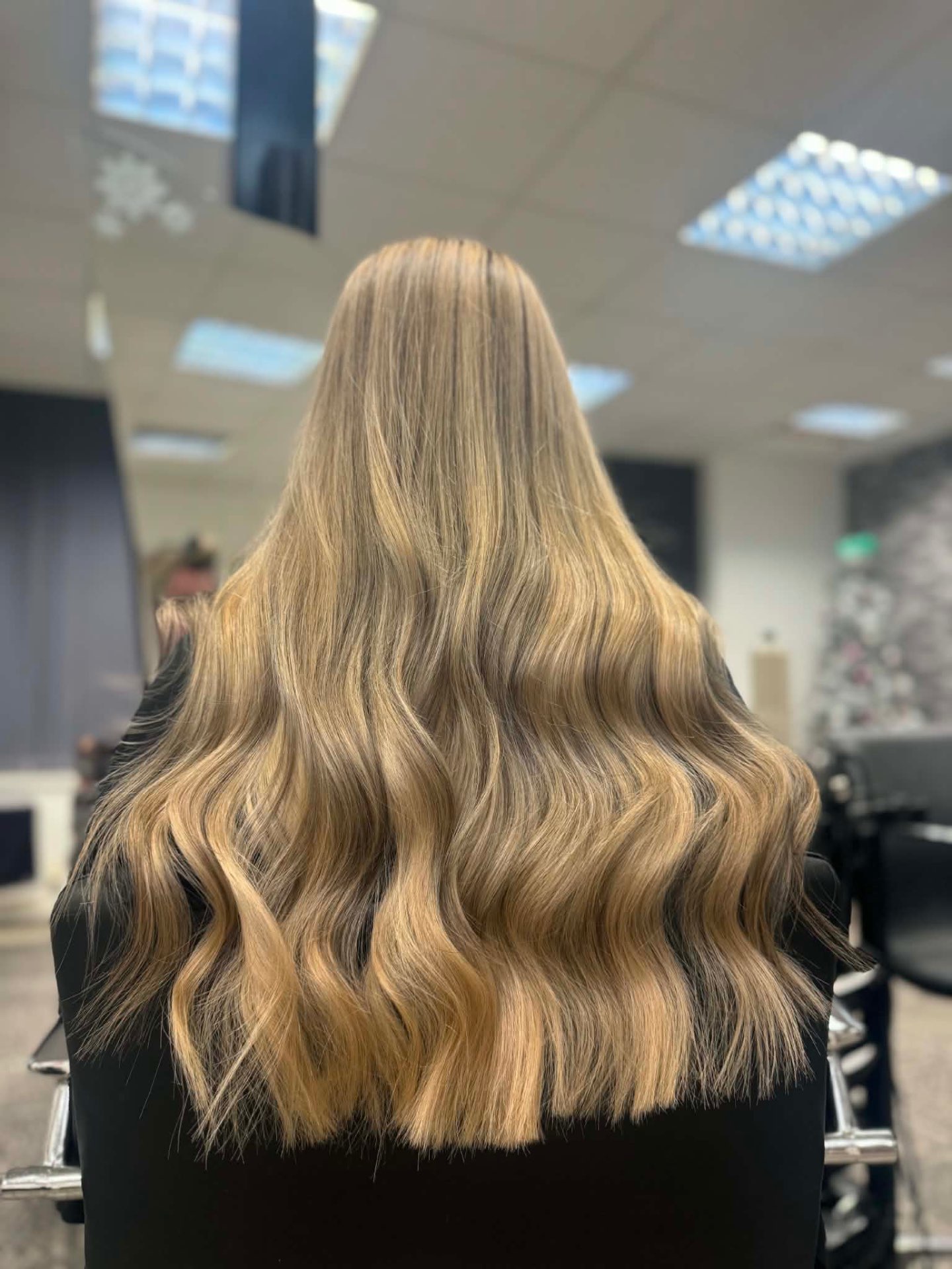 Soft blonde hairstyle with polished curls by Natasha Miller