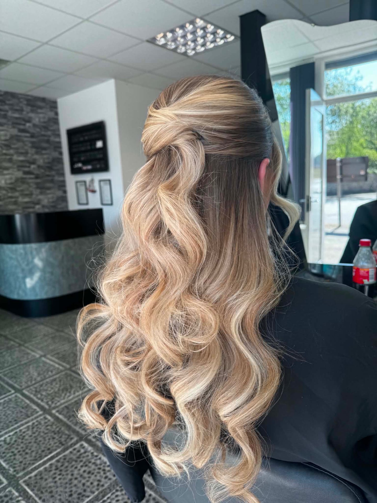 Blonde half-up style with long flowing curls