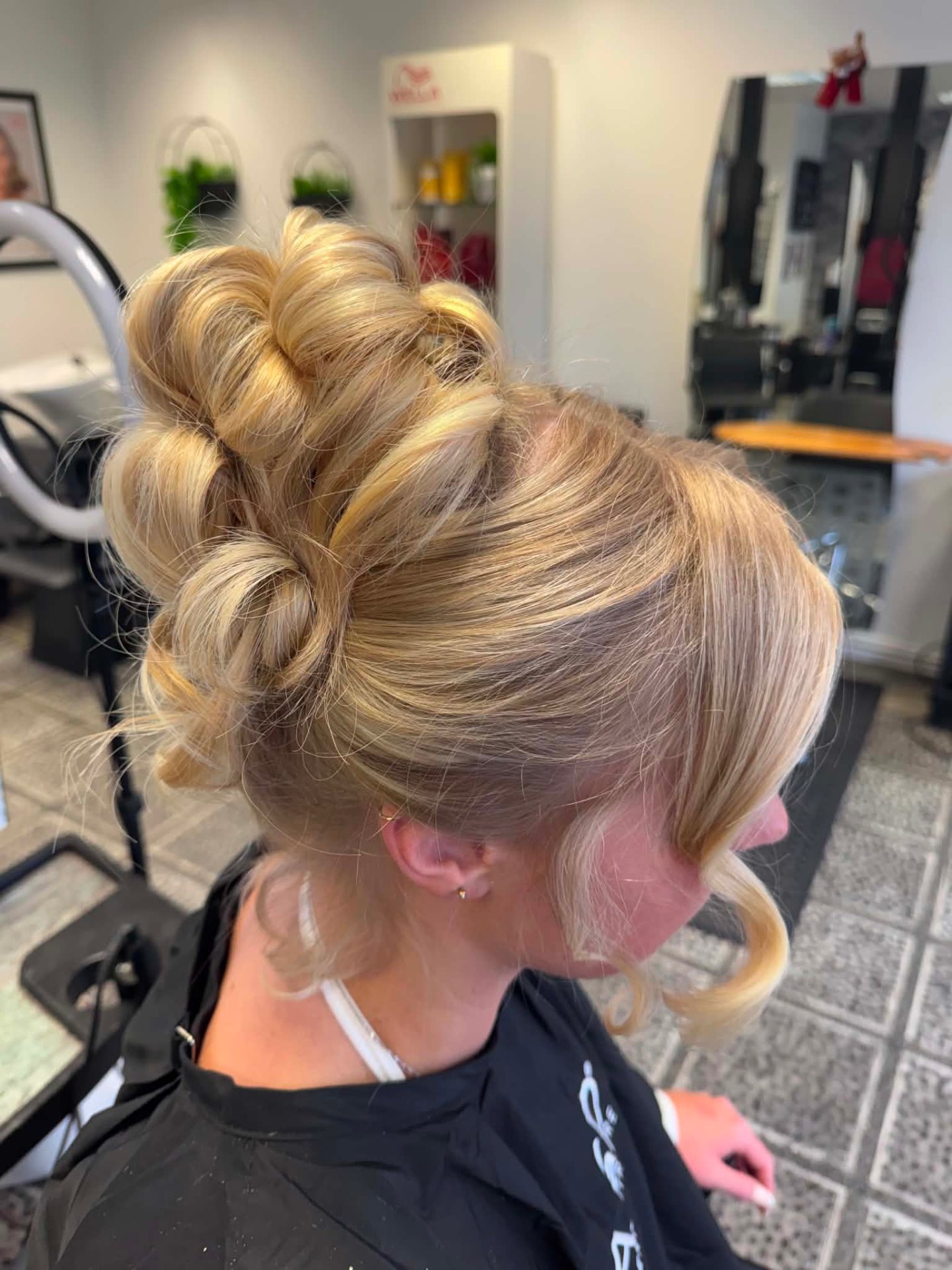 Blonde rolled high updo with structured volume