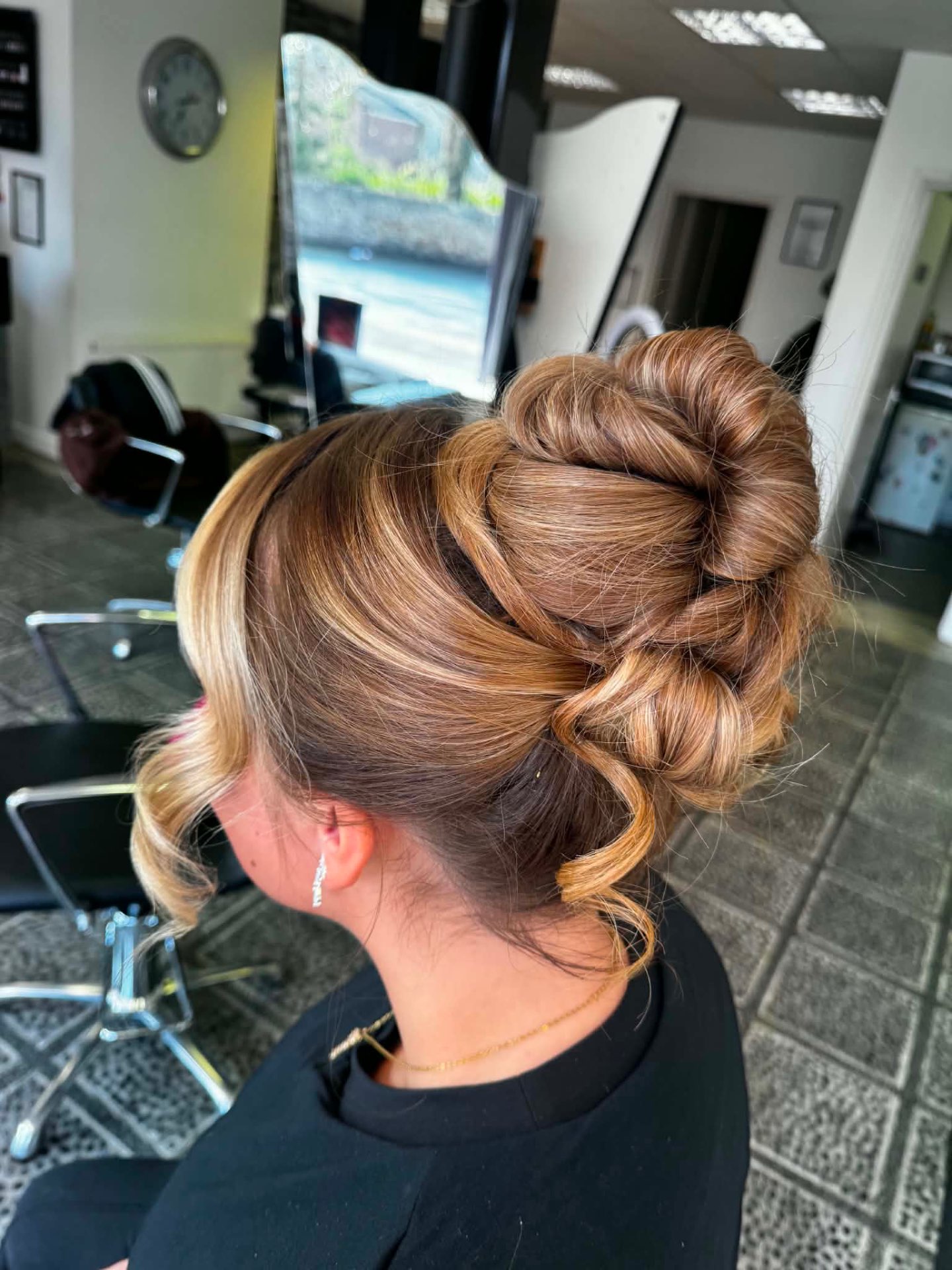 Caramel blonde twisted high bun updo